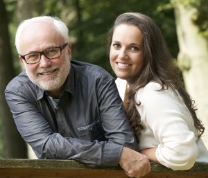 Mature father and young daughter smiling outdoors