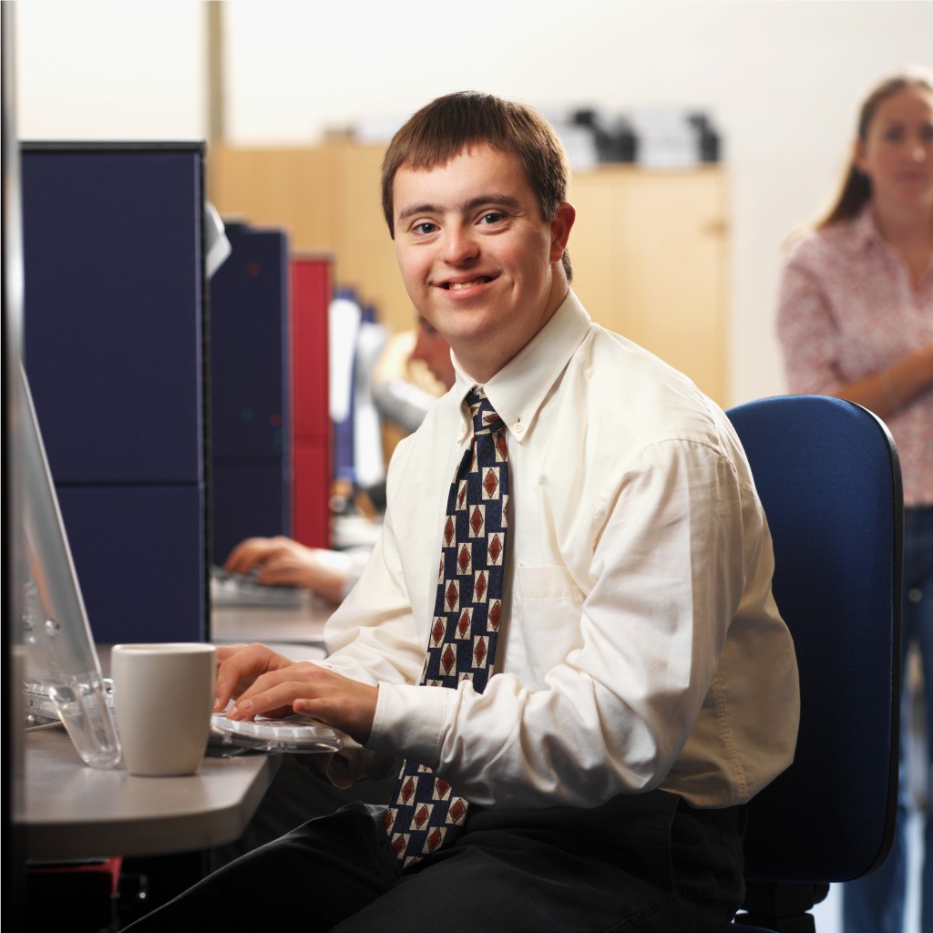 portrait of a man with down syndrome working in an office